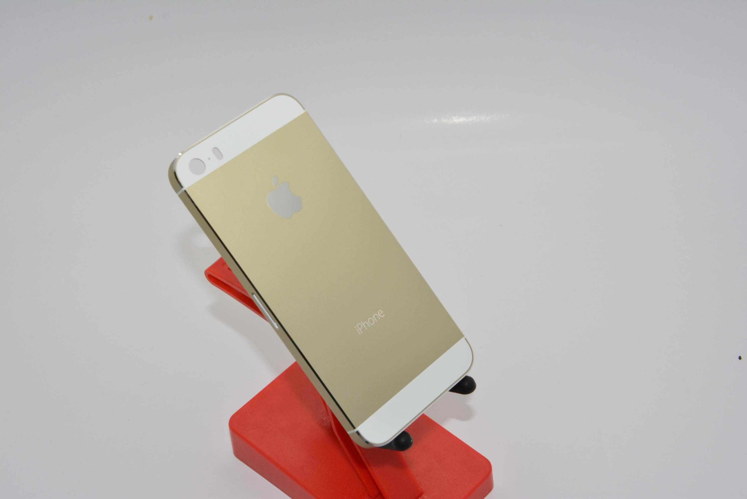 gold smartphone on red stand