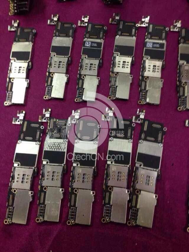 smartphone motherboards on table