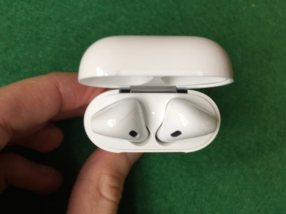 single airpod on green