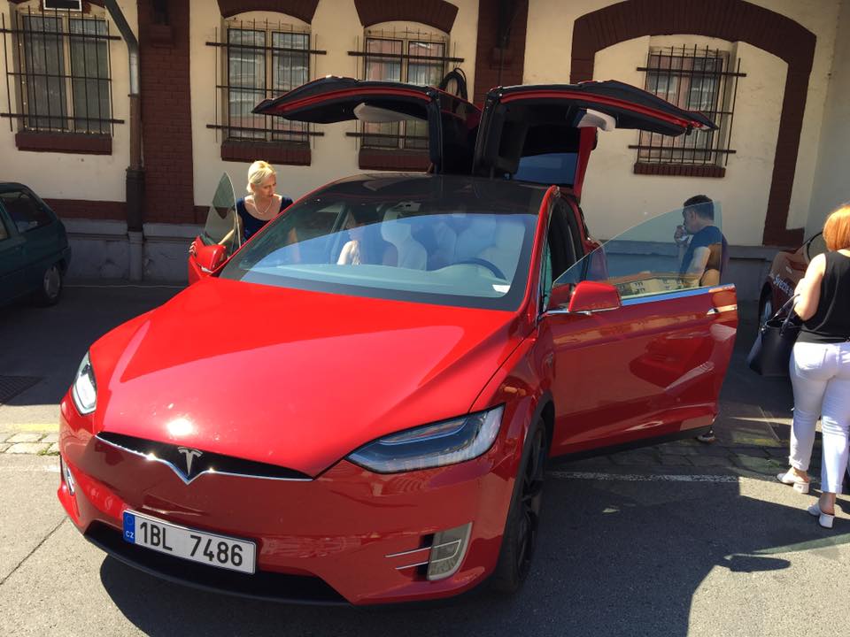 red tesla model x open doors