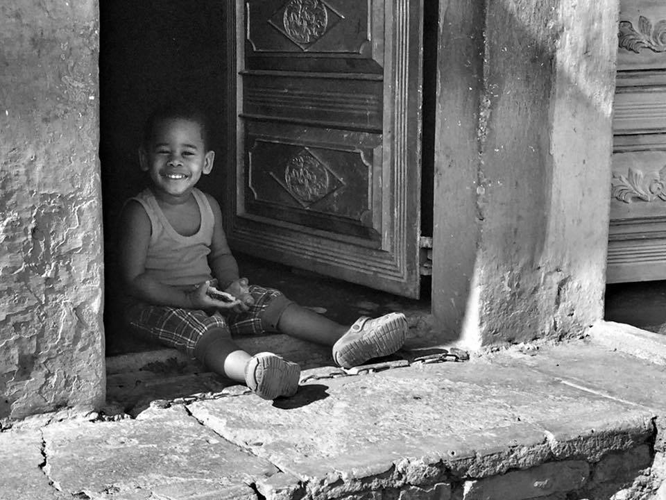 child sitting in doorway
