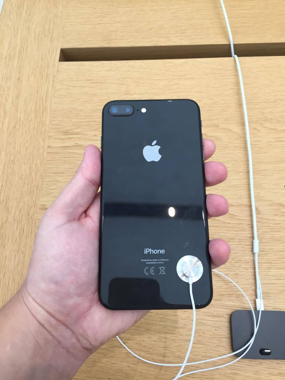 hand holding black iphone dual camera