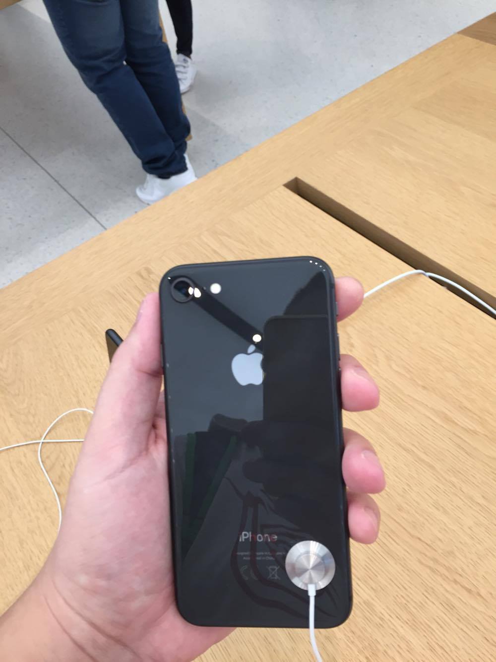 hand holding black iphone in store
