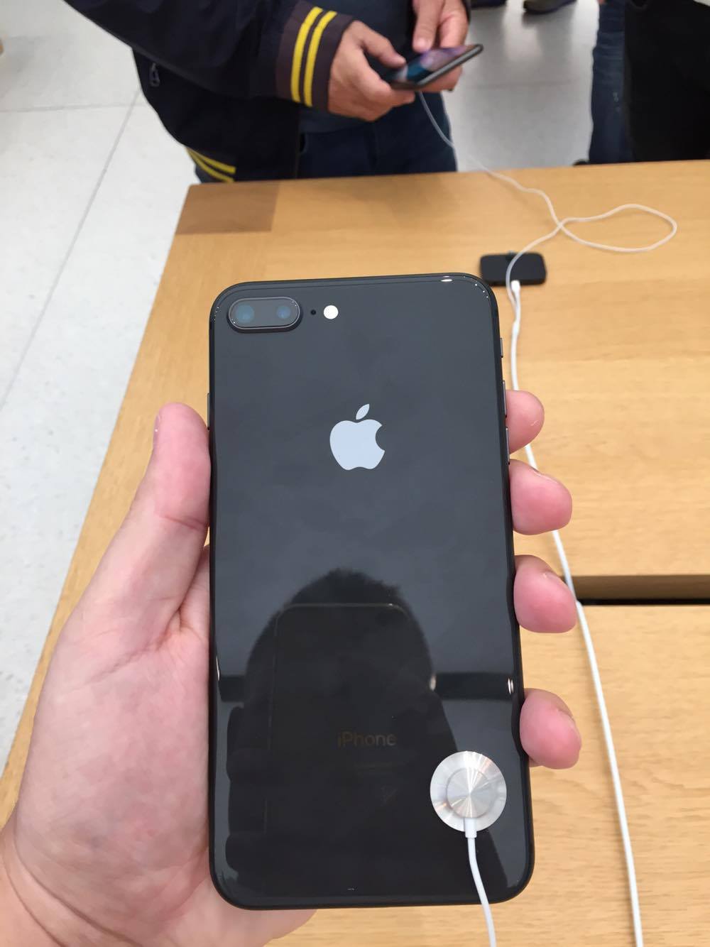 hand holding black iphone on display