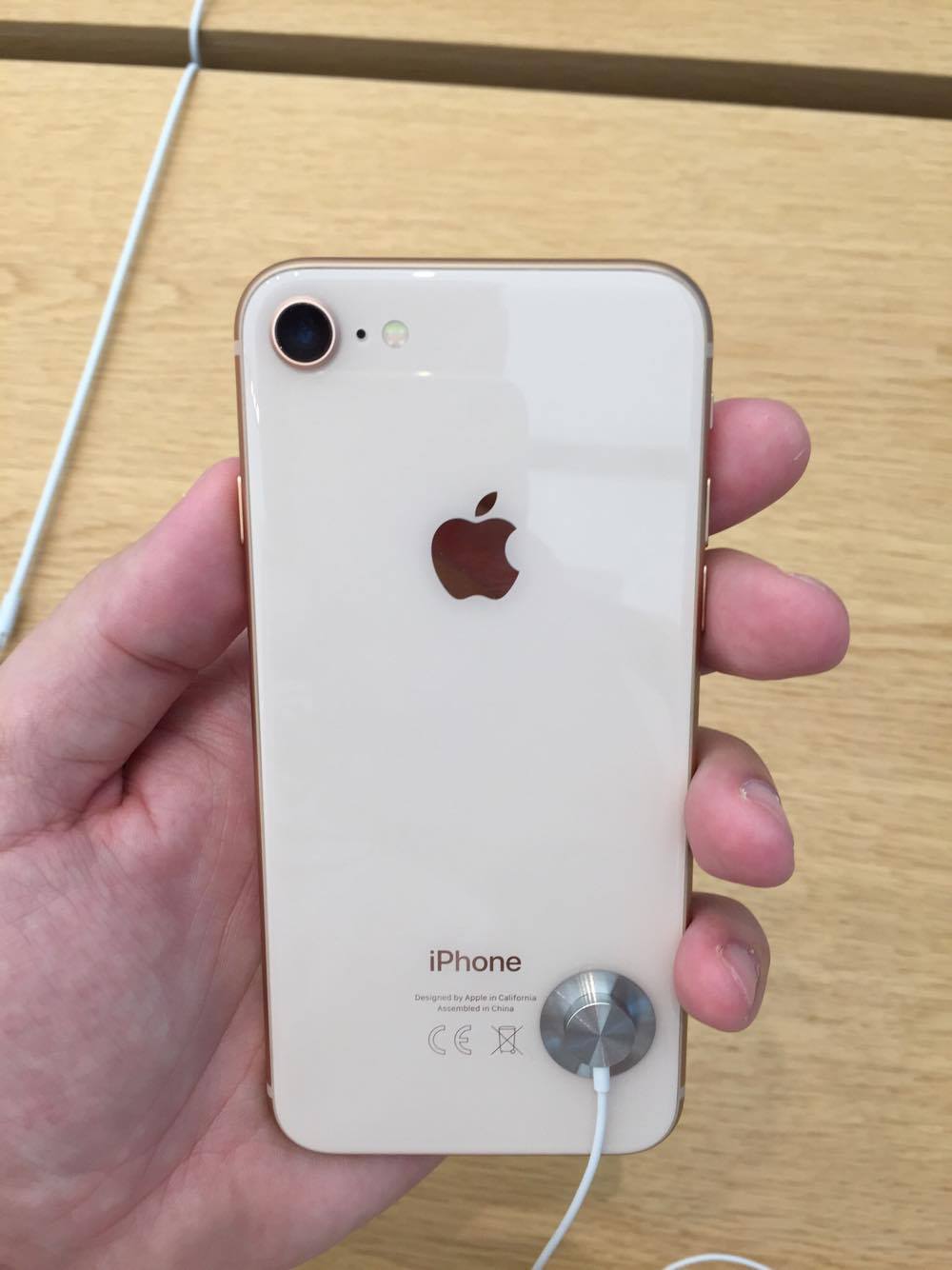 hand holding gold iphone