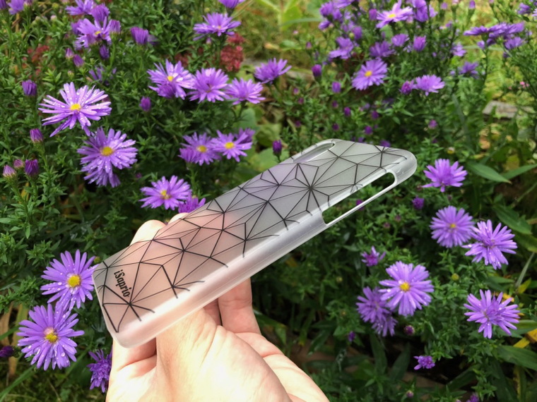 hand holding geometric phone case flowers closeup