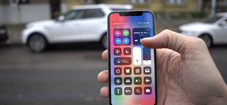 hand holding phone outdoors