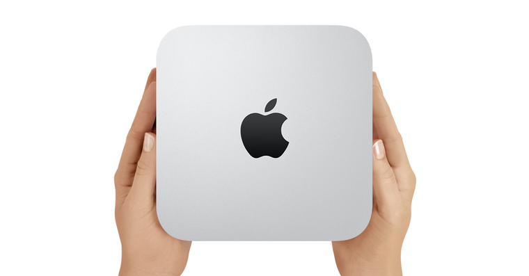 holding apple mac mini closeup