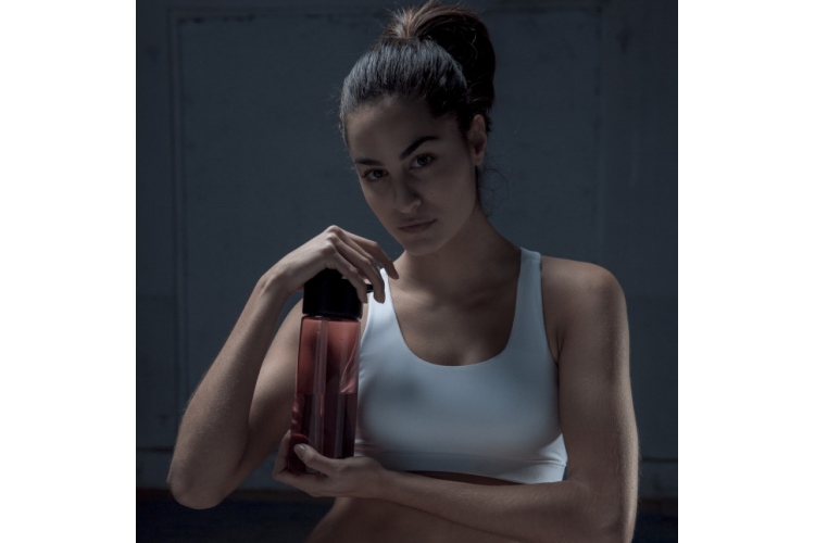 model holding red bottle