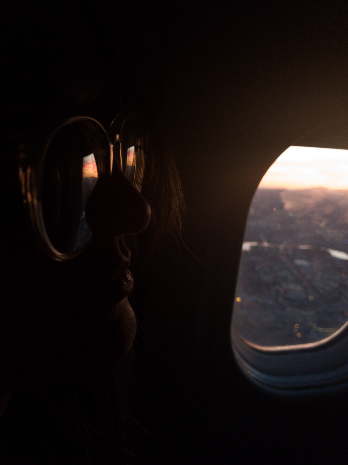 person looking out airplane window