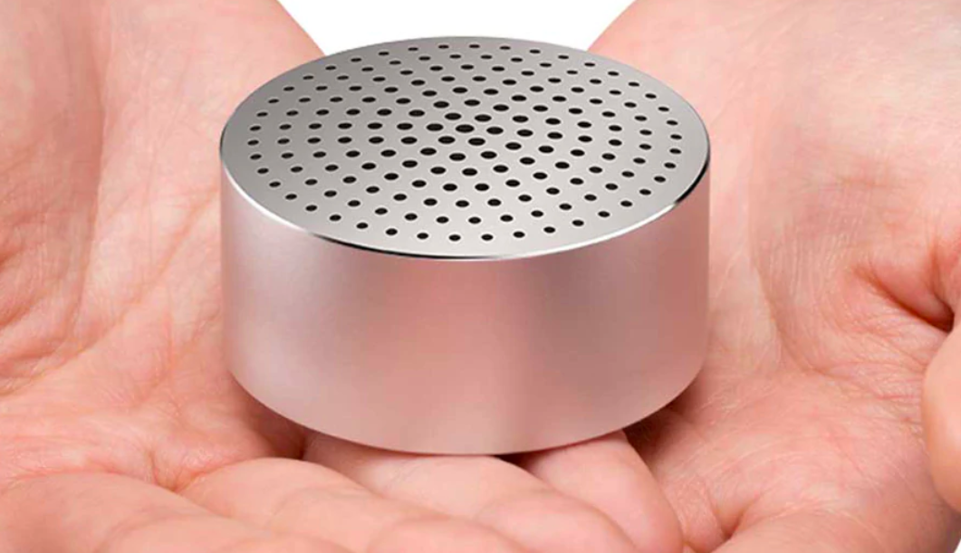 compact metal speaker in hands