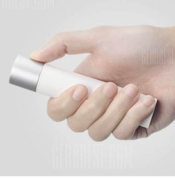 hand holding white flashlight side view