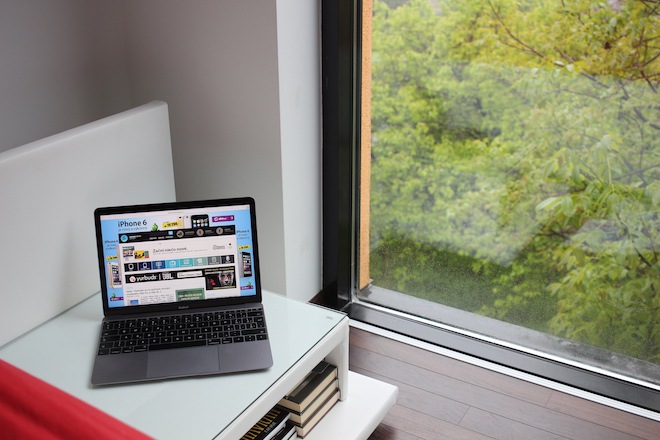 laptop on table near window