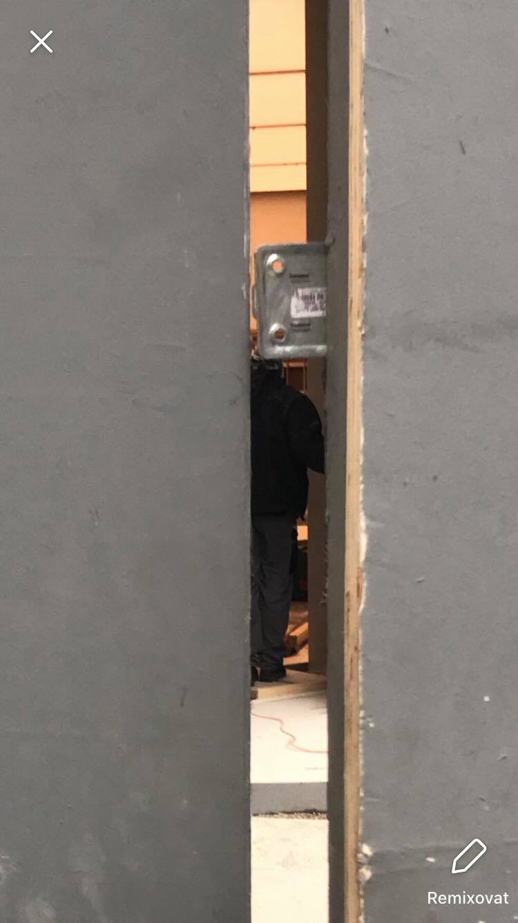 person behind door gap