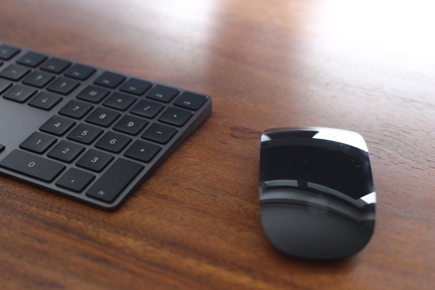 keyboard and mouse on wooden table