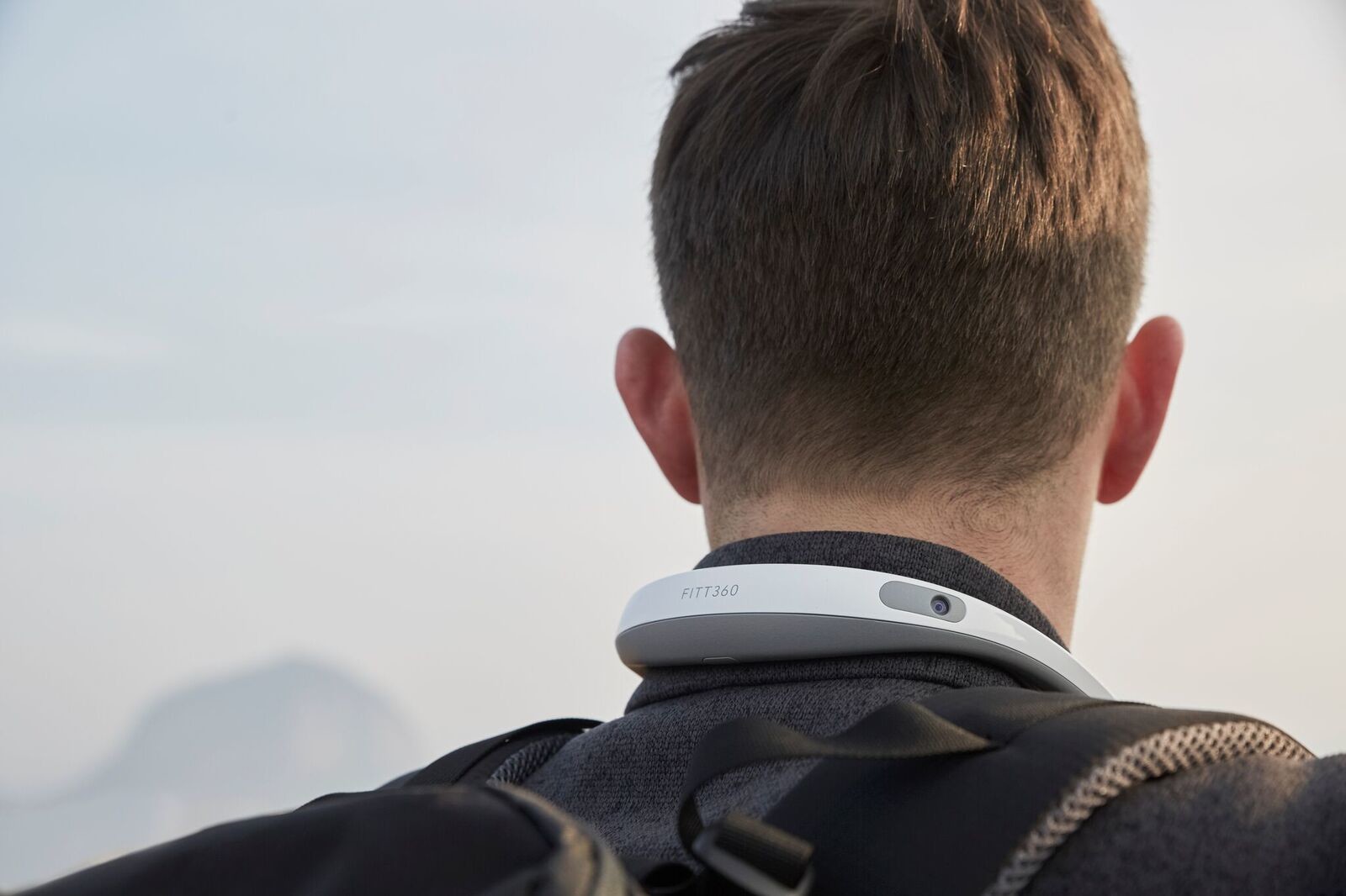 man wearing smart neckband