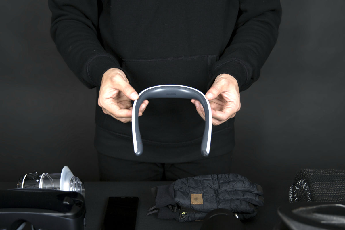 person holding neckband