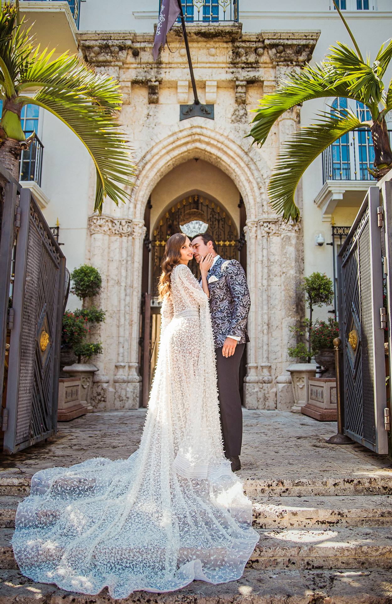 bride and groom in front of archway
