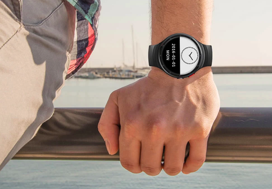 hand holding smartwatch outdoors