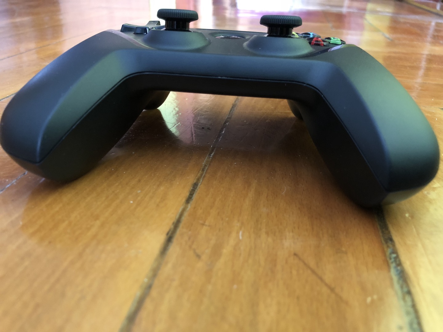 gaming controller on wooden floor