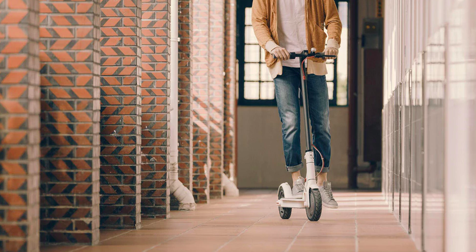 man riding scooter indoors