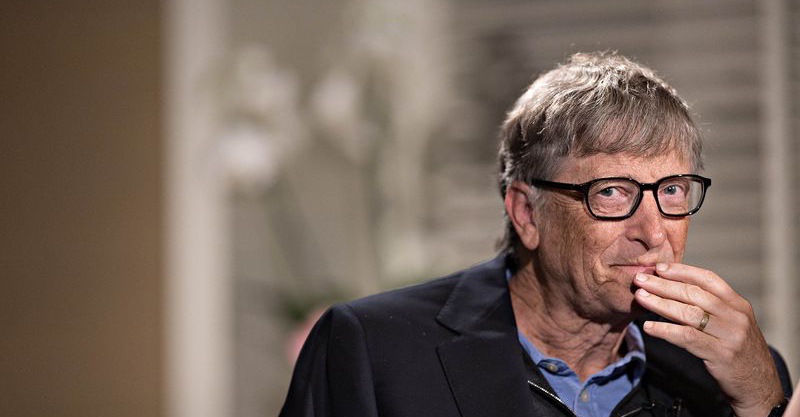 person in suit smirking