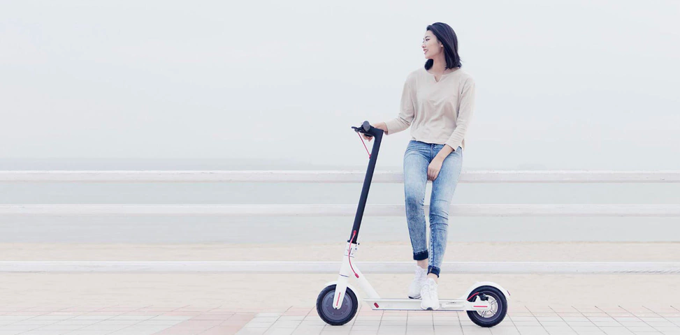 woman standing electric scooter