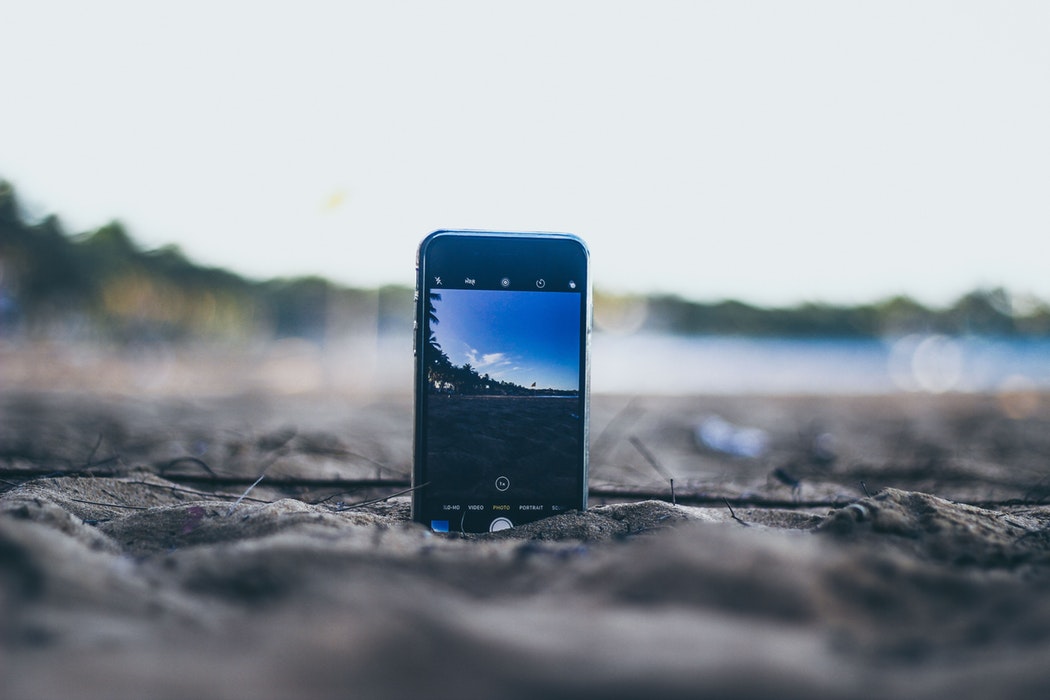 iPhone in sand Unsplash iPhone in sand Unsplash