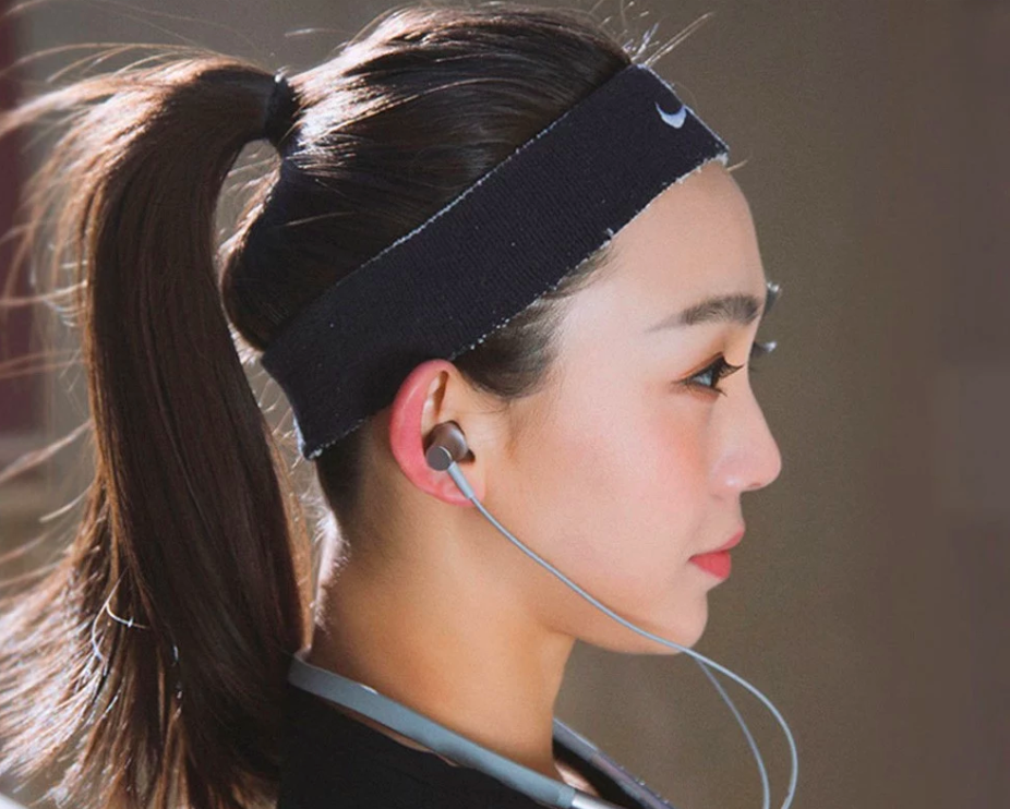 person wearing neckband earphones