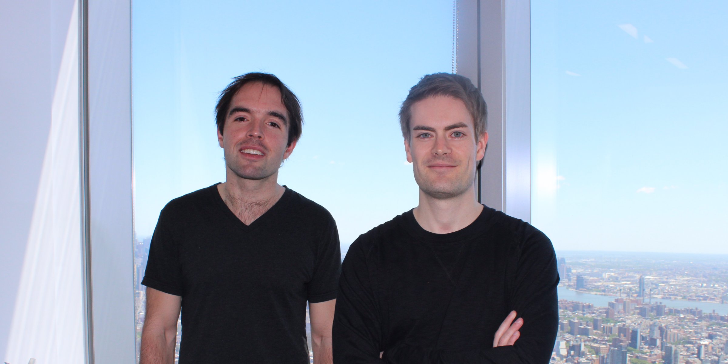 two men in front of window