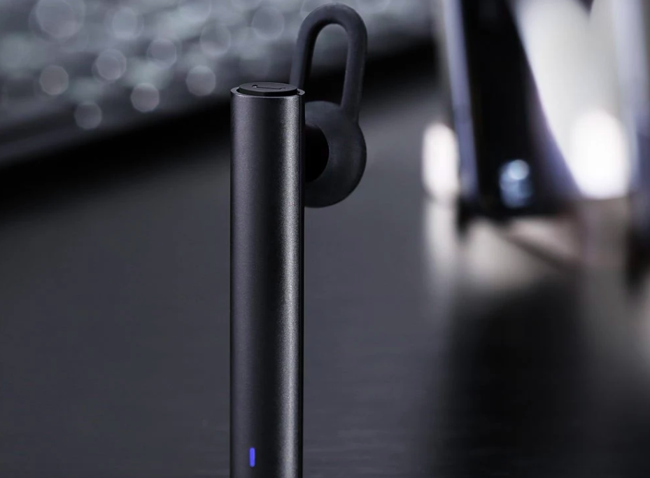 black bluetooth earpiece on desk