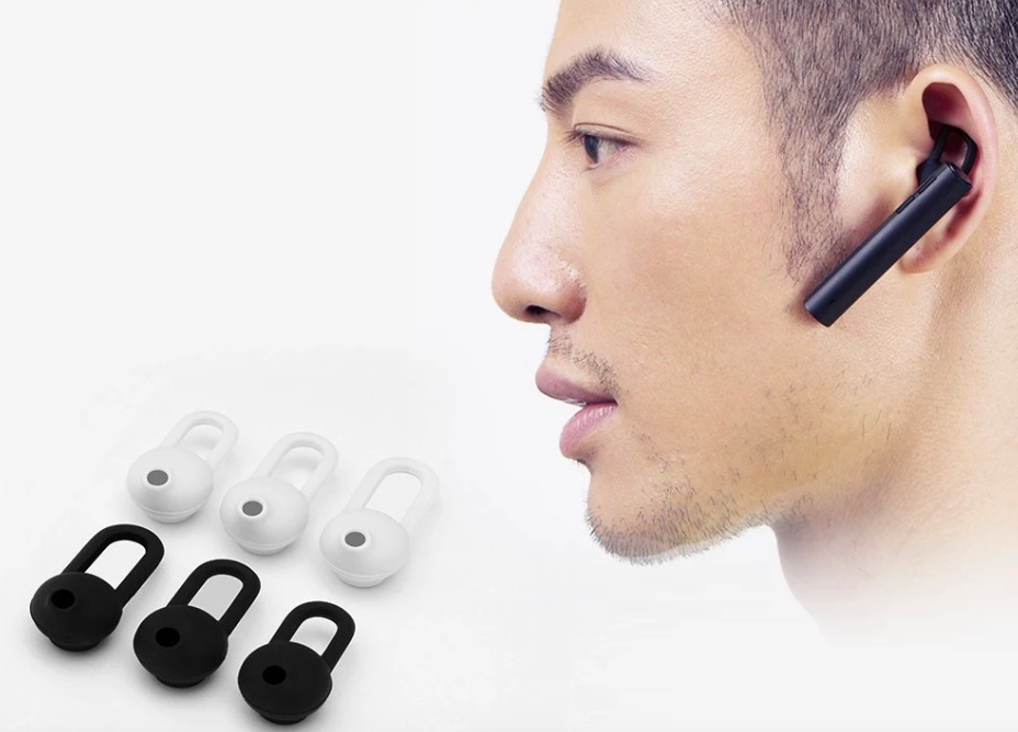 man wearing bluetooth earpiece with accessories
