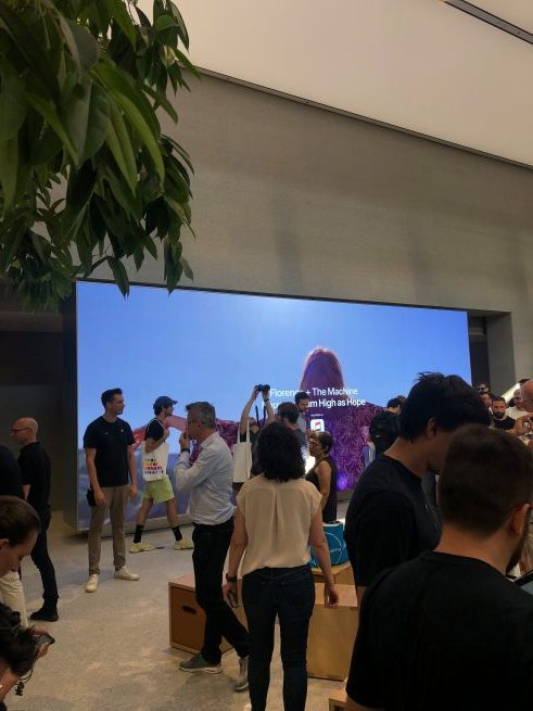 people in store with large screen