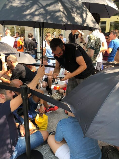 people under umbrellas outside