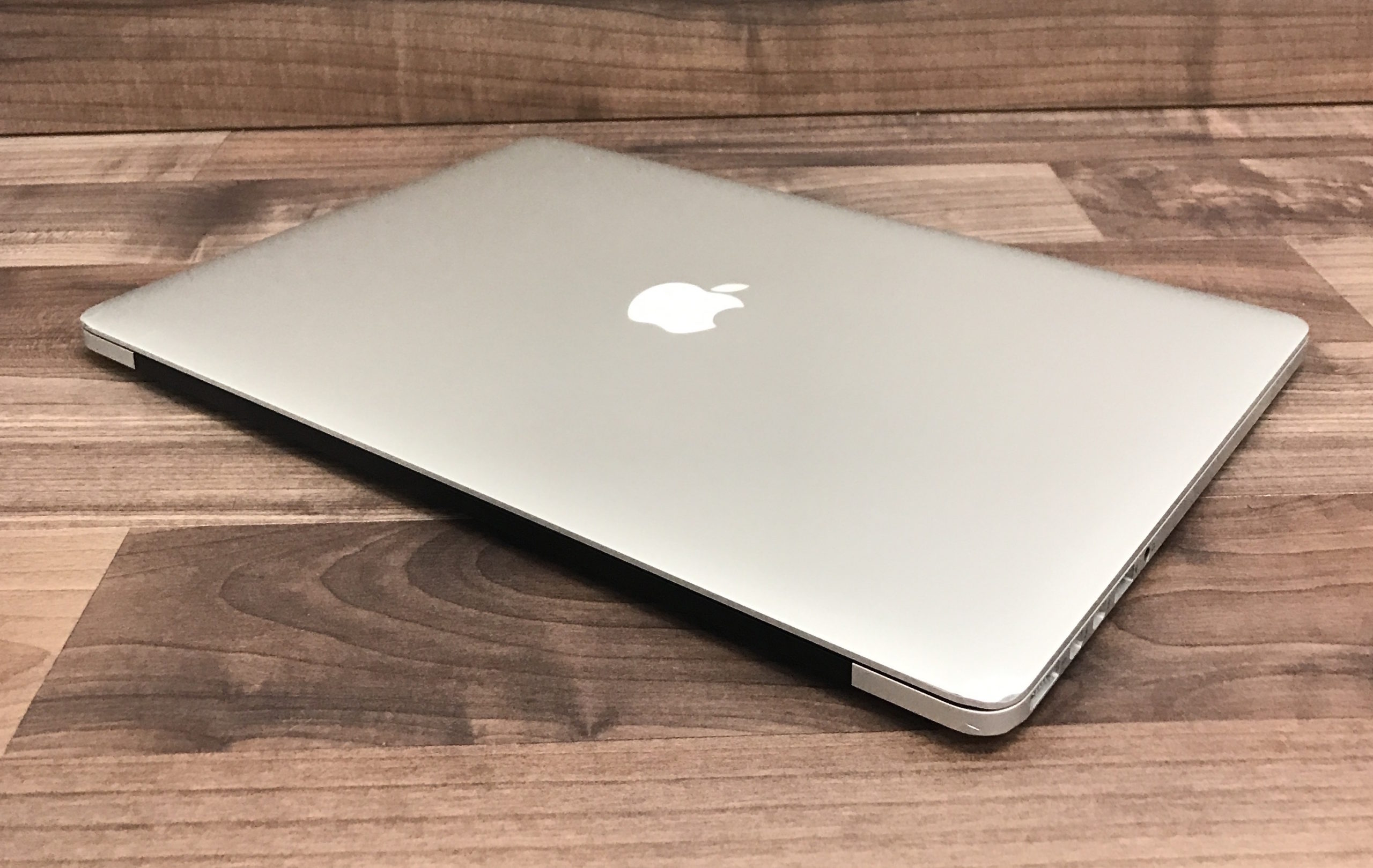 side view silver laptop wooden background