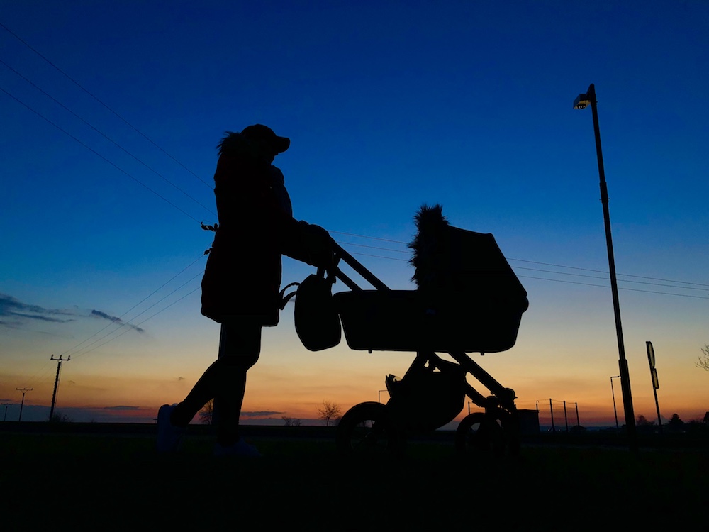 silhouette woman stroller sunset