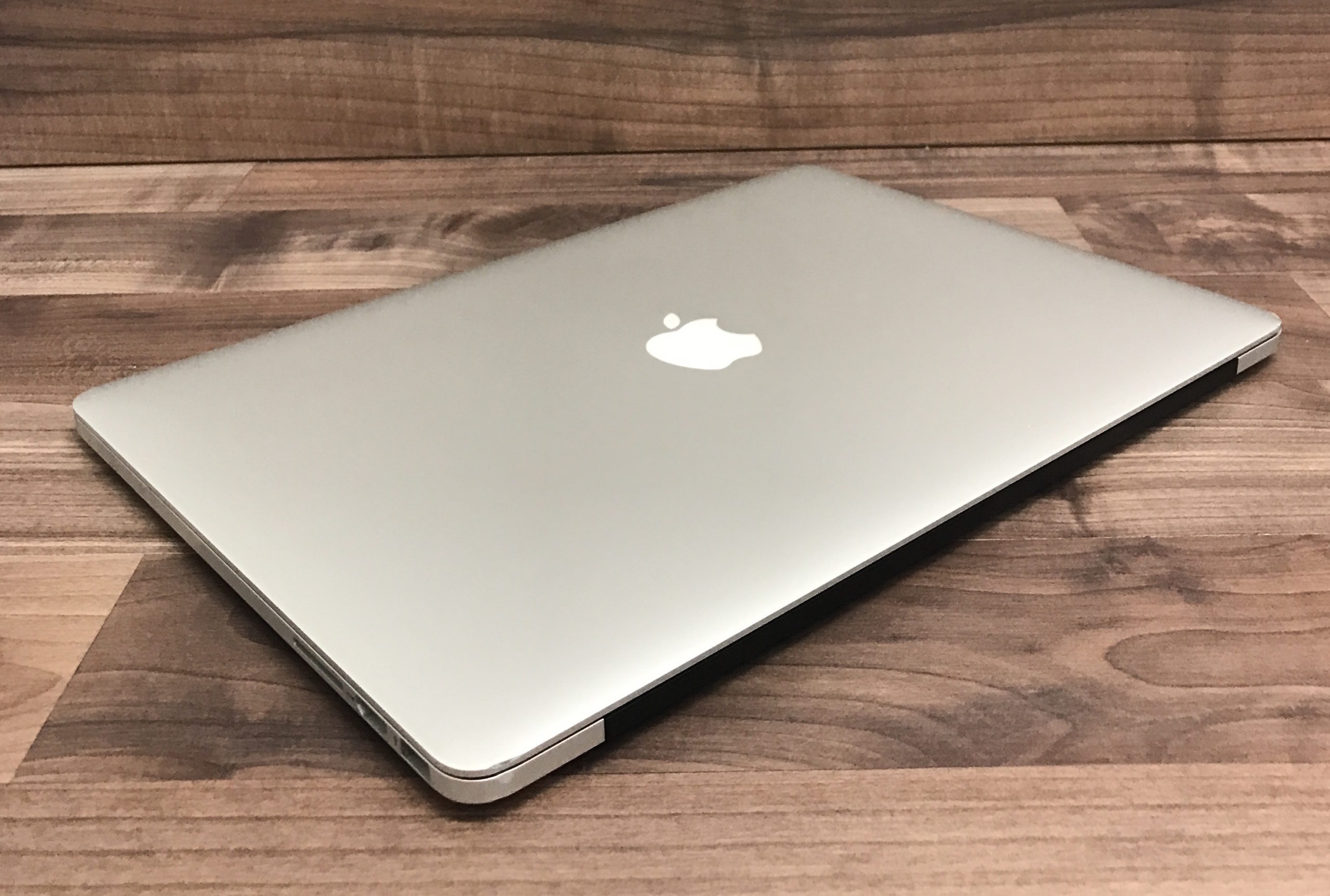 slightly open silver laptop wooden table