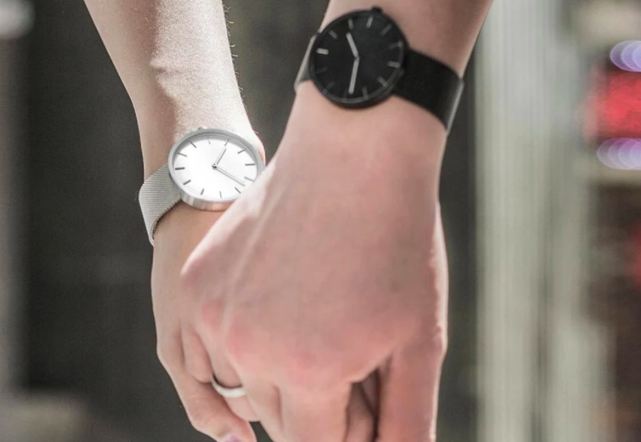 couple holding hands watches
