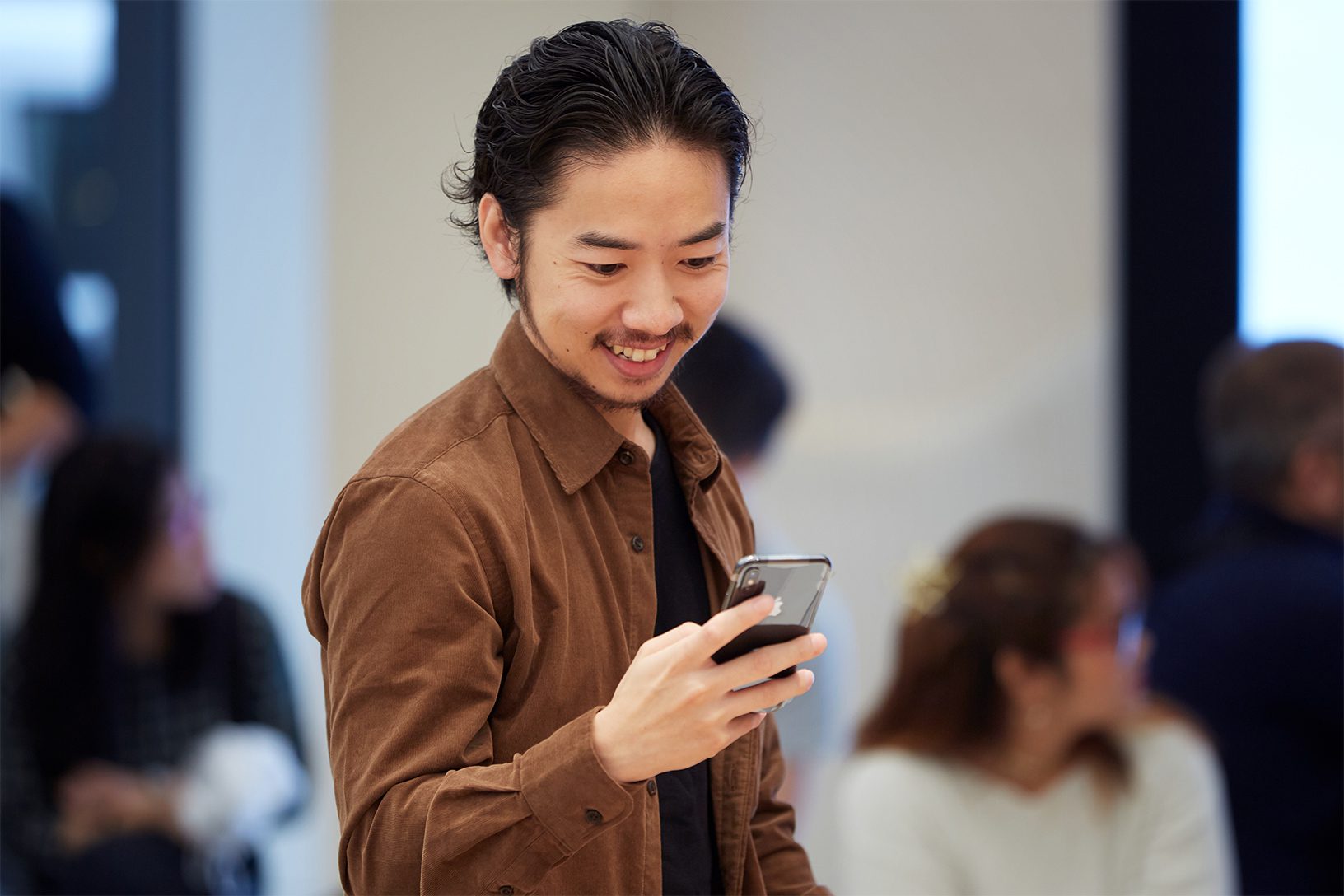 man smiling at phone