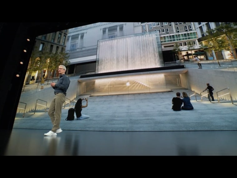 person presenting in front of waterfall image