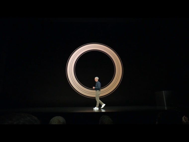 person walking in front of circle display