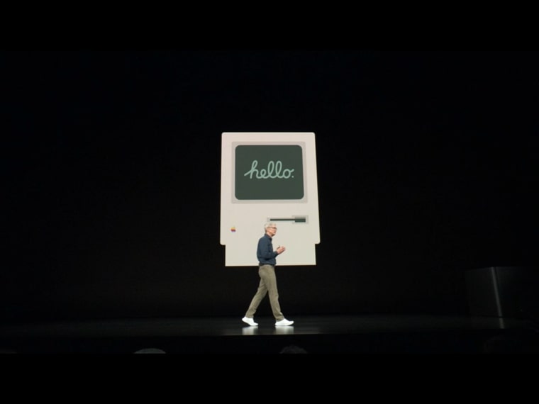 person walking in front of hello display