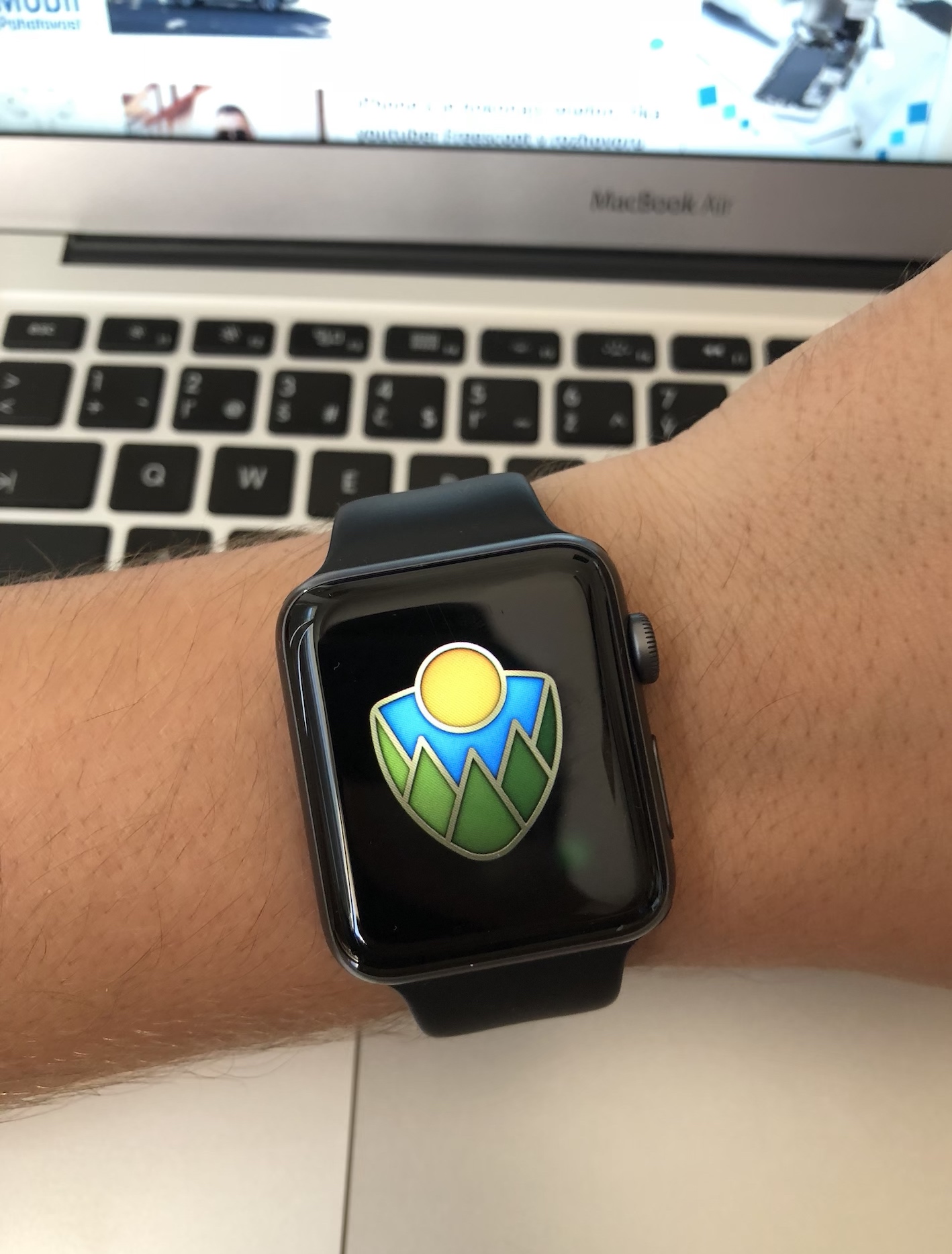 smartwatch with badge on wrist