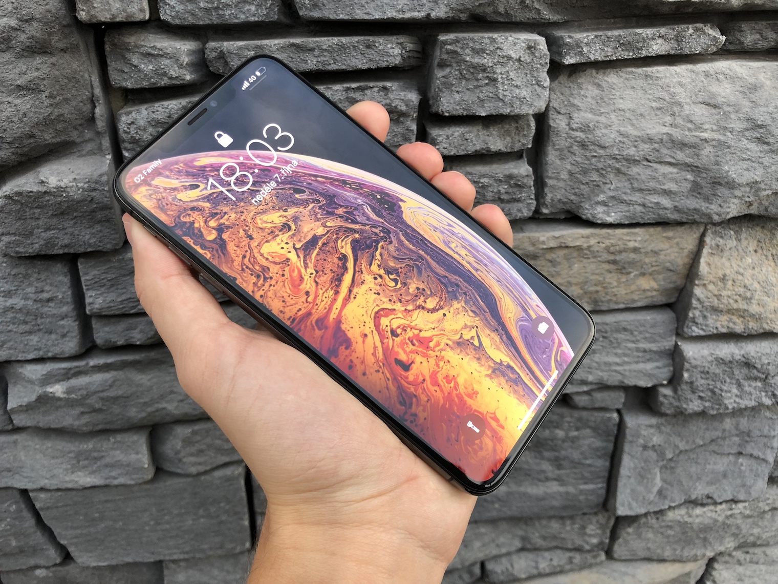 hand holding smartphone front display