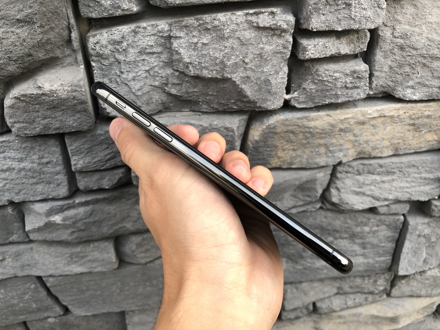 hand holding smartphone side buttons