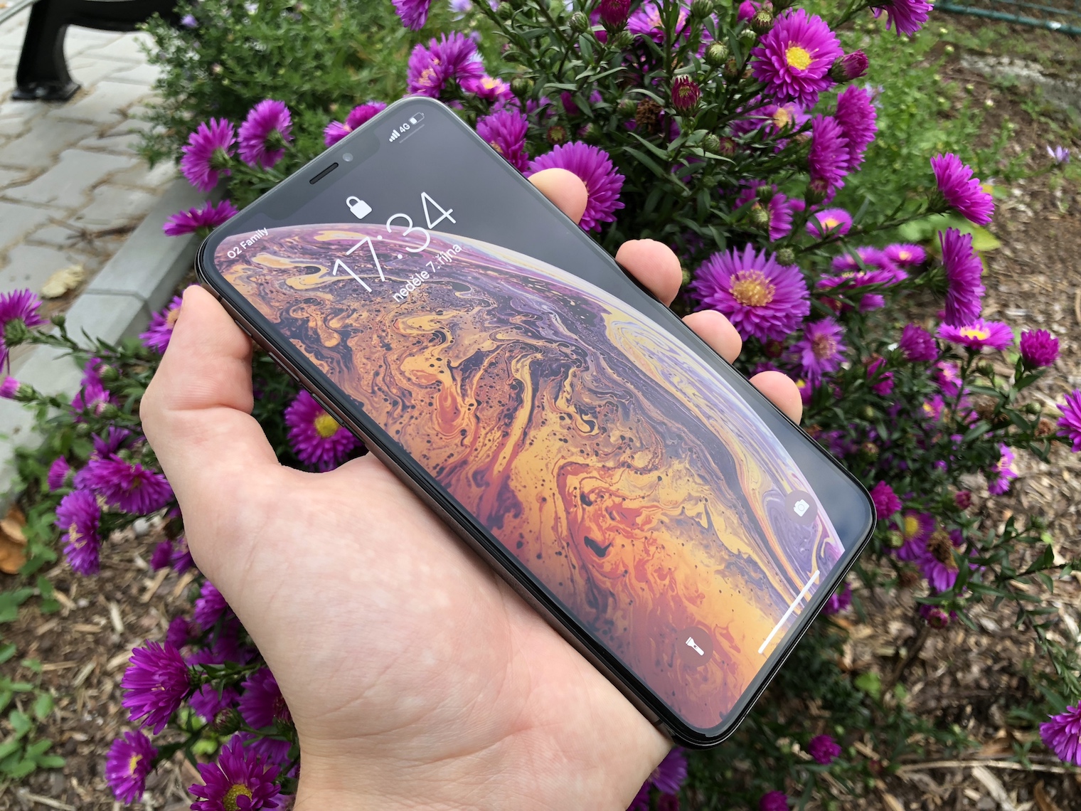 holding iphone front view flowers