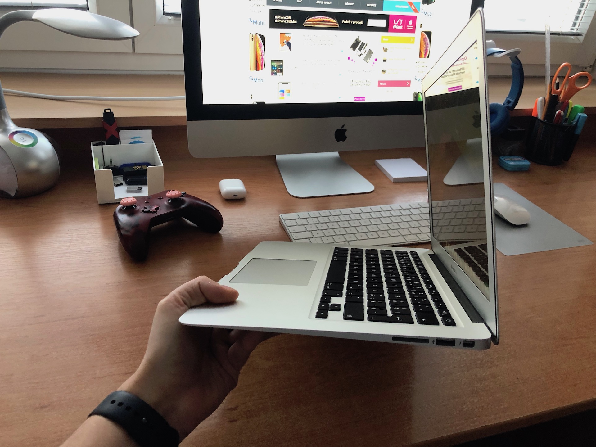 holding macbook air side view