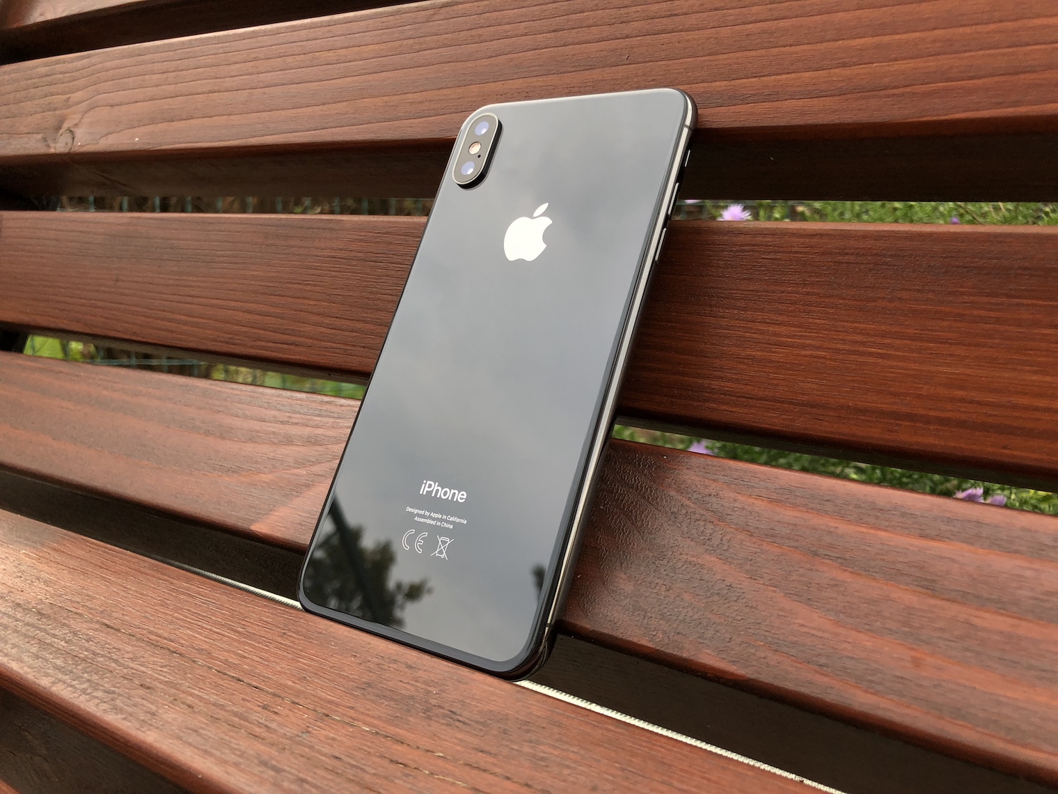 iphone on wooden bench back angle