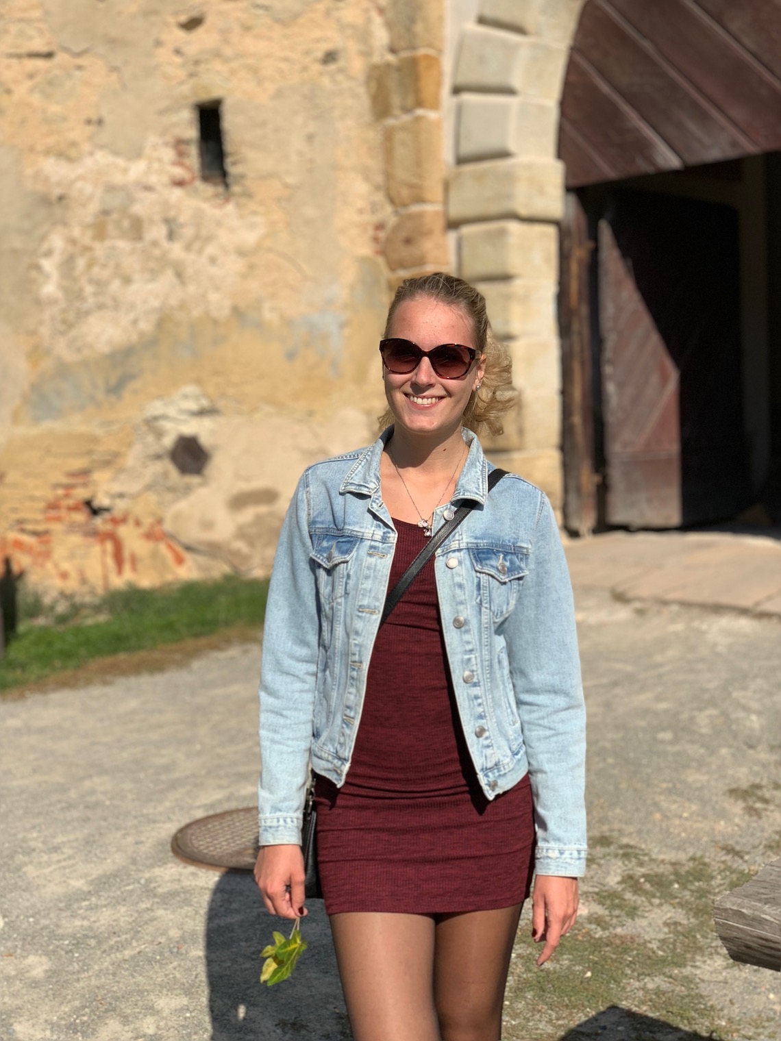 person in sunglasses outside castle