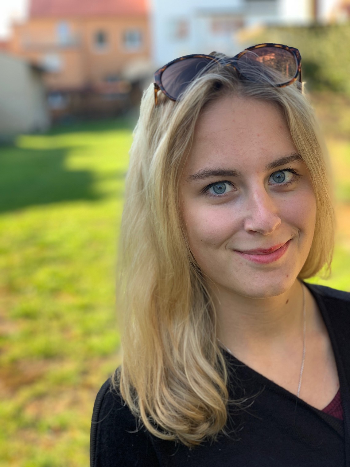 person smiling outdoors